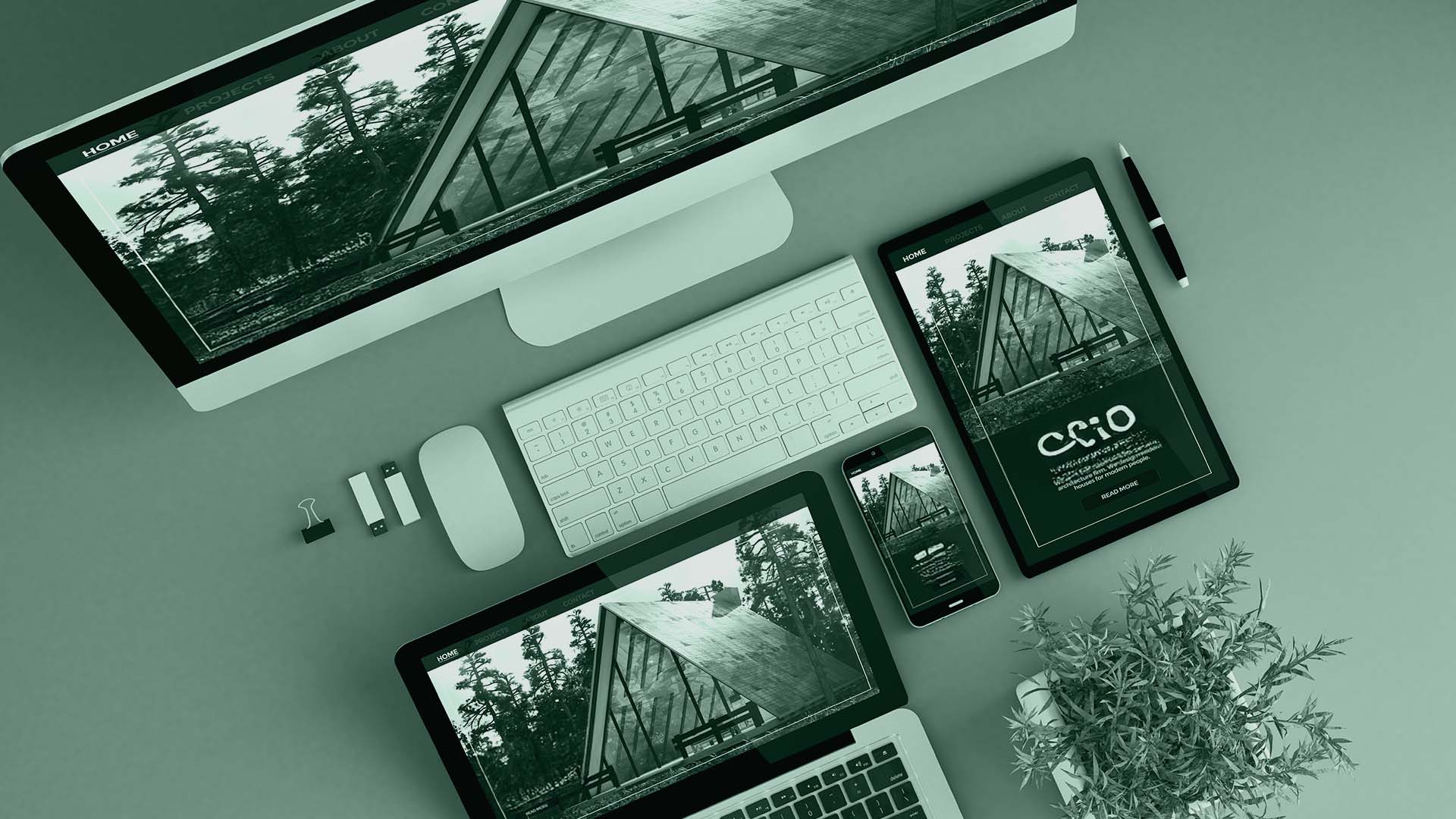 Top-down view of a website displayed across multiple devices including a laptop, tablet and phone